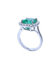 3.69 ct. cushion cut Colombian emerald engagement ring with diamond halo in 18K white gold.
