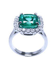 In this photo the emerald Cushion cut shows the side view of the ring, revealing the top of the gemstone and part of the ring band.