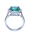 The position of this cushion cut emerald and diamond ring is lateral displaying the top and gallery profile.