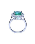 The position of this cushion cut emerald and diamond ring is lateral displaying the top and gallery profile.
