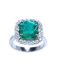 This cushion cut natural Colombian emerald ring for women has a halo of genuine diamond and is made of 18k white gold.