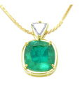 Gold necklace with a cushion cut natural emerald pendant on a white background