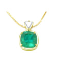 Gold necklace with a cushion cut natural emerald pendant on a white background