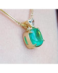 Cushion cut 4.84 ct. emerald pendant in 18K yellow gold on a delicate chain.