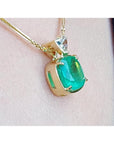 Cushion cut 4.84 ct. emerald pendant in 18K yellow gold on a delicate chain.