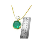 Cushion cut 4.84 ct. natural Colombian emerald pendant in 18K yellow gold on a delicate chain.