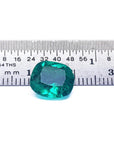 GIA certified cushion cut Colombian emerald, front side table and crown view, next to a ruler for measuring size