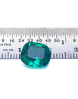 GIA certified 3.13 carat natural Colombian emerald with cushion cut, vivid bluish-green hue, next to a ruler.