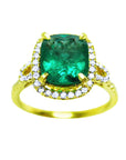 Topside profile of cushion cut emerald ring with halo diamonds and sideways profile in yellow gold.