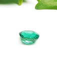 GIA-certified 1.62 carat cushion cut emerald with vibrant bluish-green hue.