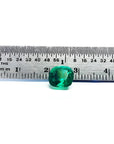 2.06 carat cushion cut Muzo Colombian emerald, sparkling medium-deep bluish green, shown with a ruler.