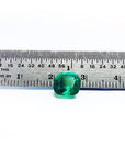 2.06 carat cushion cut Muzo Colombian emerald, sparkling medium-deep bluish green, shown with a ruler.
