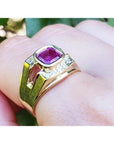 Men's 18K yellow gold ring with a bezel-set cushion-cut purplish-pink sapphire and diamond accents.