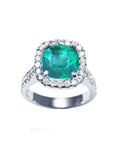 A women's natural colombian emerald ring cushion cut with halo natural diamond crafted in 14k white gold.
