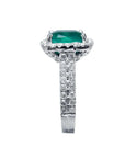 Cushion cut 3.92 ct. natural emerald ring in 14K white gold with diamond halo and pavé band.