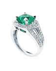 A half side profile of a white gold emerald ring for women white background.