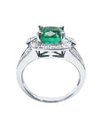 The lateral top and gallery view of this white gold emerald ring on a white background.