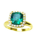 A natural cushion cut emerald ring for women with halo diamond showcasing the stone from its top view.