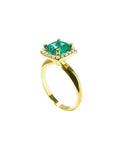 A yellow gold emerald cushion cut ring on its half side profile view from the top to the band.