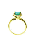 14K gold ring with a 1.45 ct cushion-cut emerald and diamond halo.