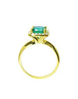14K gold ring with a 1.45 ct cushion-cut emerald and diamond halo.