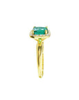 The side profile of this natural emerald ring displays the side of the gem and downside of the band.