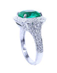 A top downside profile of a bridals' May birthstone emerald engagement ring.