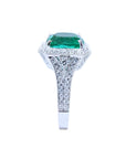 Cushion cut 3.68 ct Colombian emerald engagement ring with diamond halo and pavé band in 18K white gold.