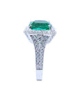 Cushion cut 3.68 ct Colombian emerald engagement ring with diamond halo and pavé band in 18K white gold.