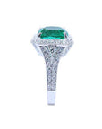 Cushion cut 3.68 ct Colombian emerald engagement ring with diamond halo and pavé band in 18K white gold.
