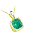 A yellow gold pendant with a cushion cut natural emerald in the center surrounded by a halo diamond right side profile.