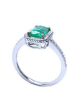 The half side of a cushion cut emerald solitaire ring showcasing the top and gallery with band profile.