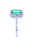 A clean side profile perspective of this natural emerald ring showing the top setting and band with diamonds studded.