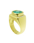 Men's 18k yellow gold ring with a cushion-cut emerald and channel-set diamonds.