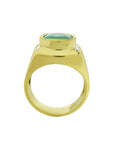 Men's 18k yellow gold ring with a cushion-cut emerald and diamond accents.