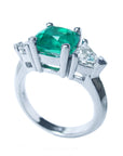 Displaying a half side of an emerald cushion cut side diamonds trillion cut white gold ring, with gallery view.