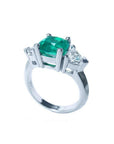 2.18 ct cushion cut Colombian emerald ring with trillion side diamonds in 14K white gold.