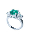 2.18 ct cushion cut Colombian emerald ring with trillion side diamonds in 14K white gold.