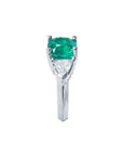 2.18 ct cushion cut emerald ring with trillion side diamonds in 14K white gold.