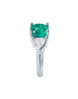 2.18 ct cushion cut emerald ring with trillion side diamonds in 14K white gold.