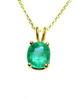 A yellow gold natural emerald cushion cut pendant on a topside view position.