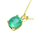 This solitaire emerald cushion cut pendant displays its left side profile, top and gallery perspectives visibles.