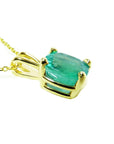 The left side profile of a cushion cut emerald solitaire pendant, top and gallery visibles.