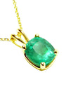 A cushion cut emerald pendant displaying its topside profile ona right side position.