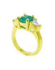 1.47 ct. emerald-cut Colombian emerald ring with trillion diamonds in 18k yellow gold.