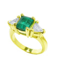 1.47 ct emerald-cut Colombian emerald ring with trillion diamonds in 18k yellow gold.