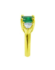 1.47 ct emerald-cut emerald and trillion diamonds ring in 18k yellow gold.