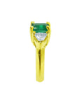 1.47 ct emerald-cut emerald and trillion diamonds ring in 18k yellow gold.