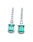 Pair of natural emerald dangle earrings with diamond accents in 18k white gold, front side top view