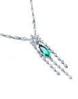 Marquise cut Colombian emerald necklace in 14K white gold with diamond links and floral accents.